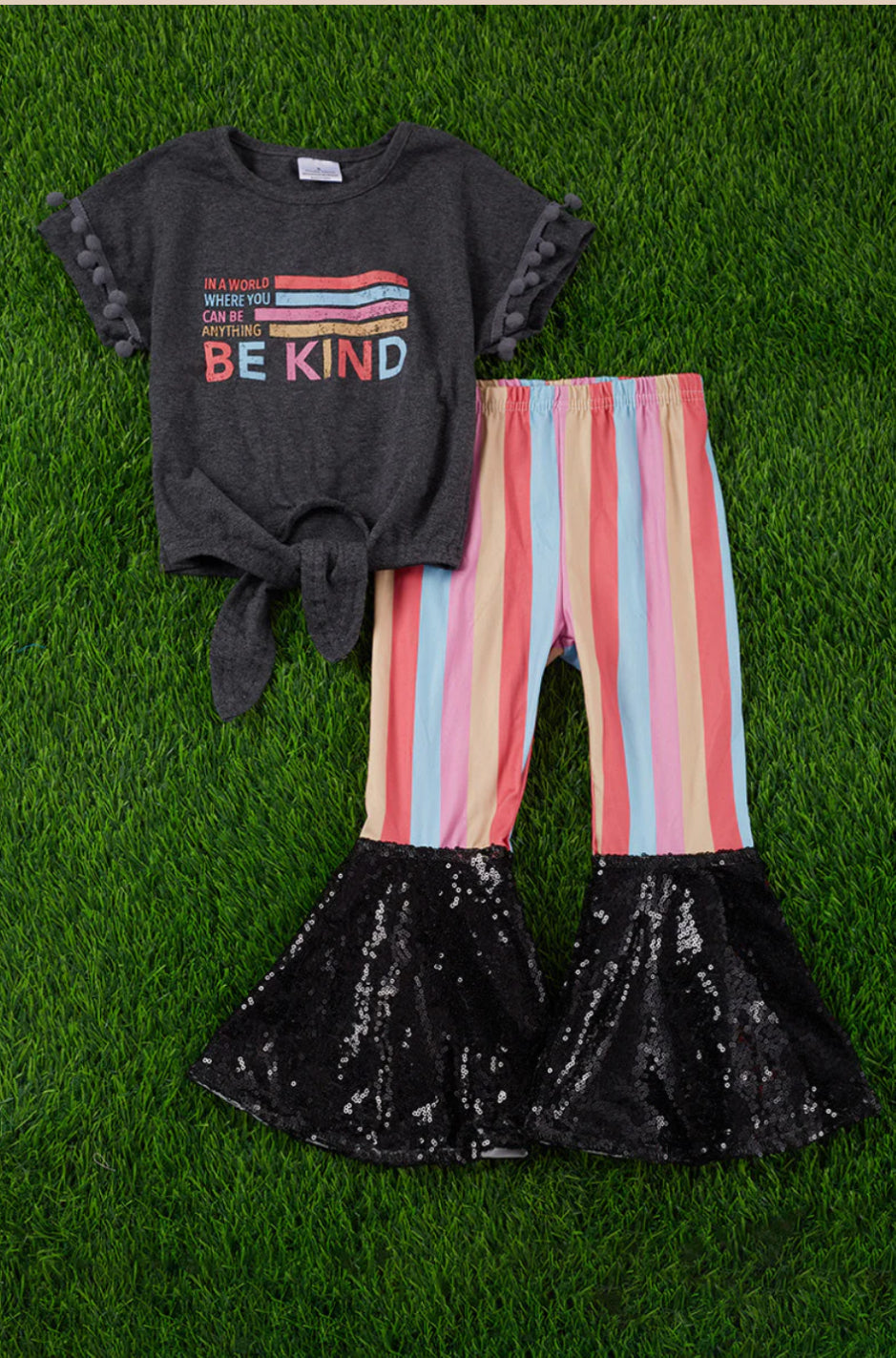 Be Kind- Charcoal Top with Be Kind Graphic and PomPom sleeves with Colorful Stripe Pants with Black Sequin Flare