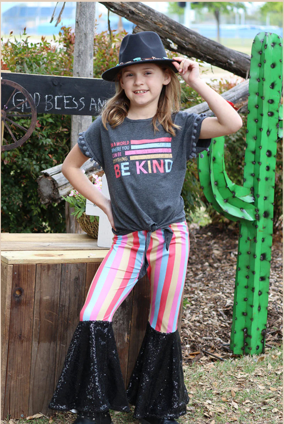 Be Kind- Charcoal Top with Be Kind Graphic and PomPom sleeves with Colorful Stripe Pants with Black Sequin Flare