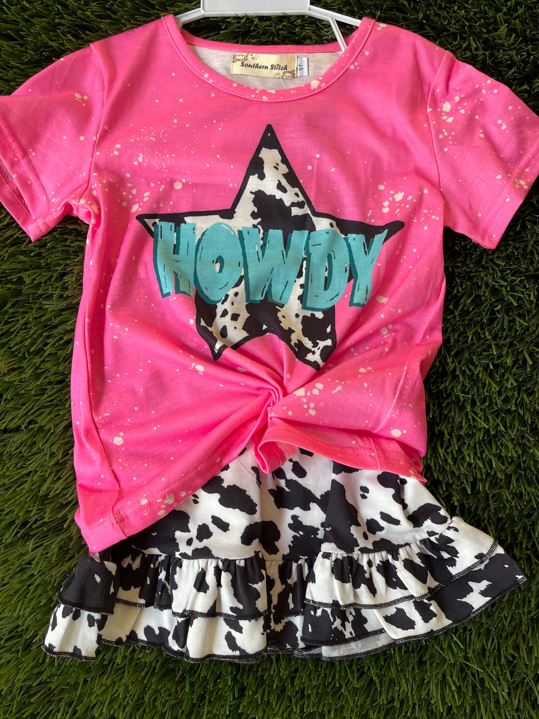 Pink Howdy top and cow printed shorts
