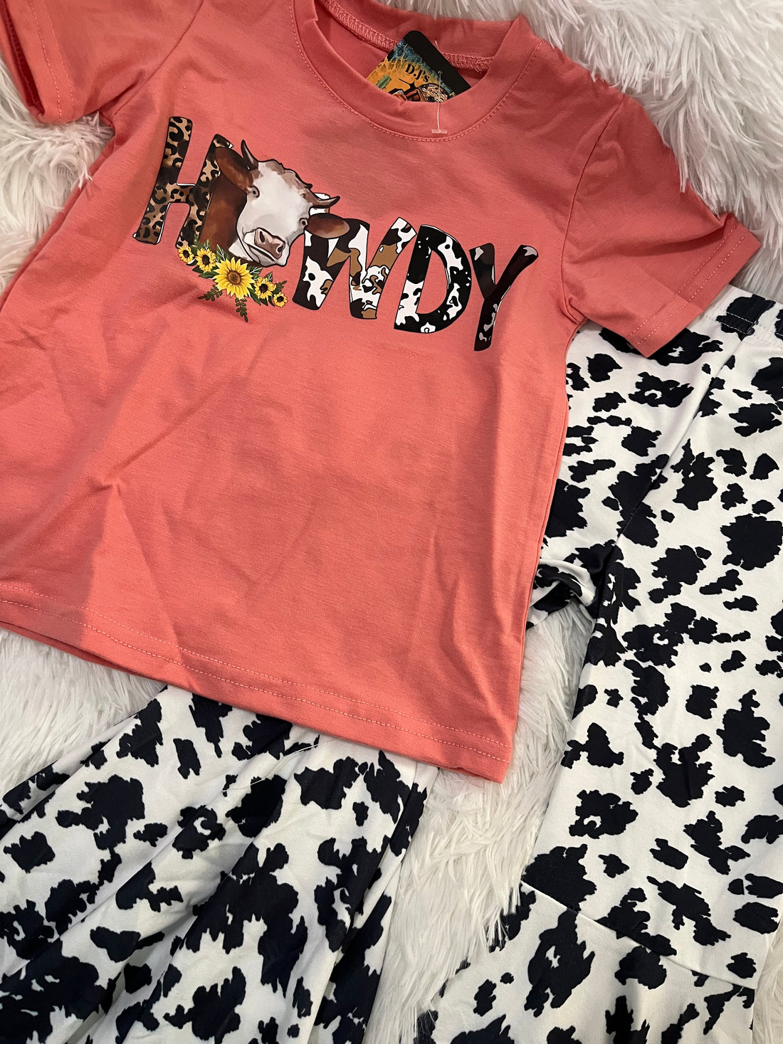 Close up View-Girls Coral Howdy Cow with Sunflowers with Cow print bell bottoms