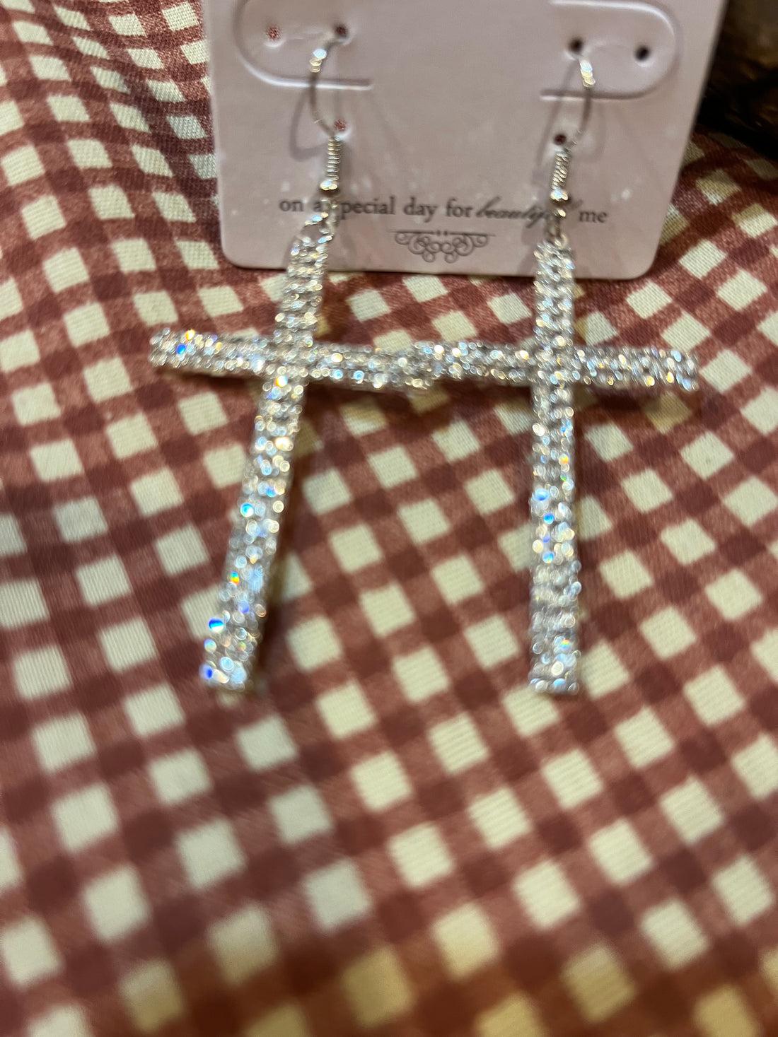 Laying View-Crystal Adorned Cross Earrings